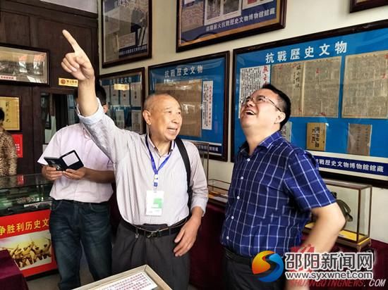 邵陽薪火抗戰(zhàn)歷史文物博覽館館長李連榮(中)在向市民介紹抗戰(zhàn)歷史文物