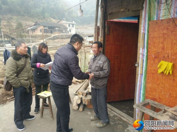 隆回县城管执法局工作人员正在走访慰问贫困户