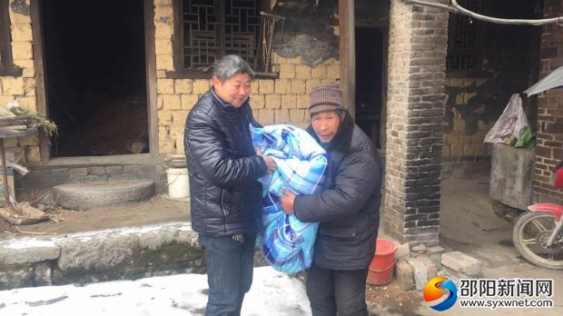 巨口铺社区唐四玉书记给贫困户送棉被