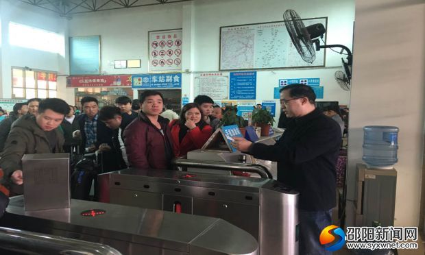 黄鑫在汽车北站实名制验票闸机前协助站务人员验票