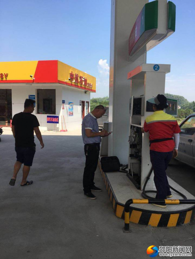 图为加油站现场检查并更换检定铅封