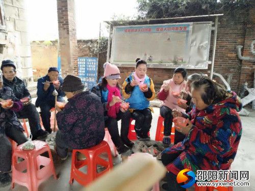 图为志愿者给老人送上热腾腾的饺子
