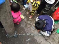 男童被母亲用铁链锁街头电线杆示众