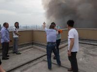 杭州一市场发生火灾 市民冒险爬楼顶围观