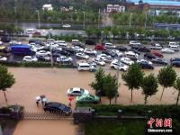 郑州暴雨致路面积水严重 行人如过河