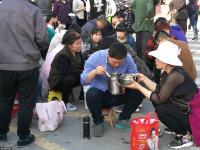 高考临近 “高考工厂”门口学生蹲地上吃饭